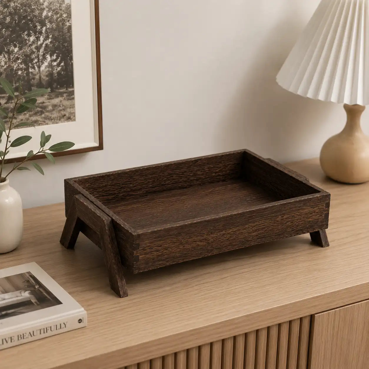 Rectangular solid wood storage tray displayed on a modern home console table with minimalist decor, showcasing its versatile design for organizing everyday essentials in living spaces.