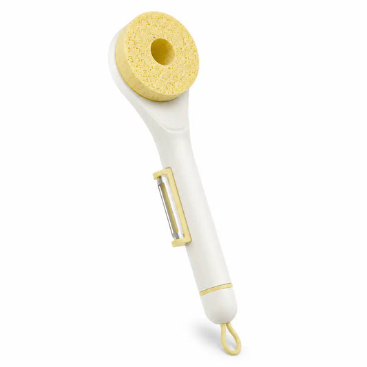 White wood pulp sponge cleaning brush with a built-in stainless steel vegetable peeler and replaceable yellow sponge head on a white background.